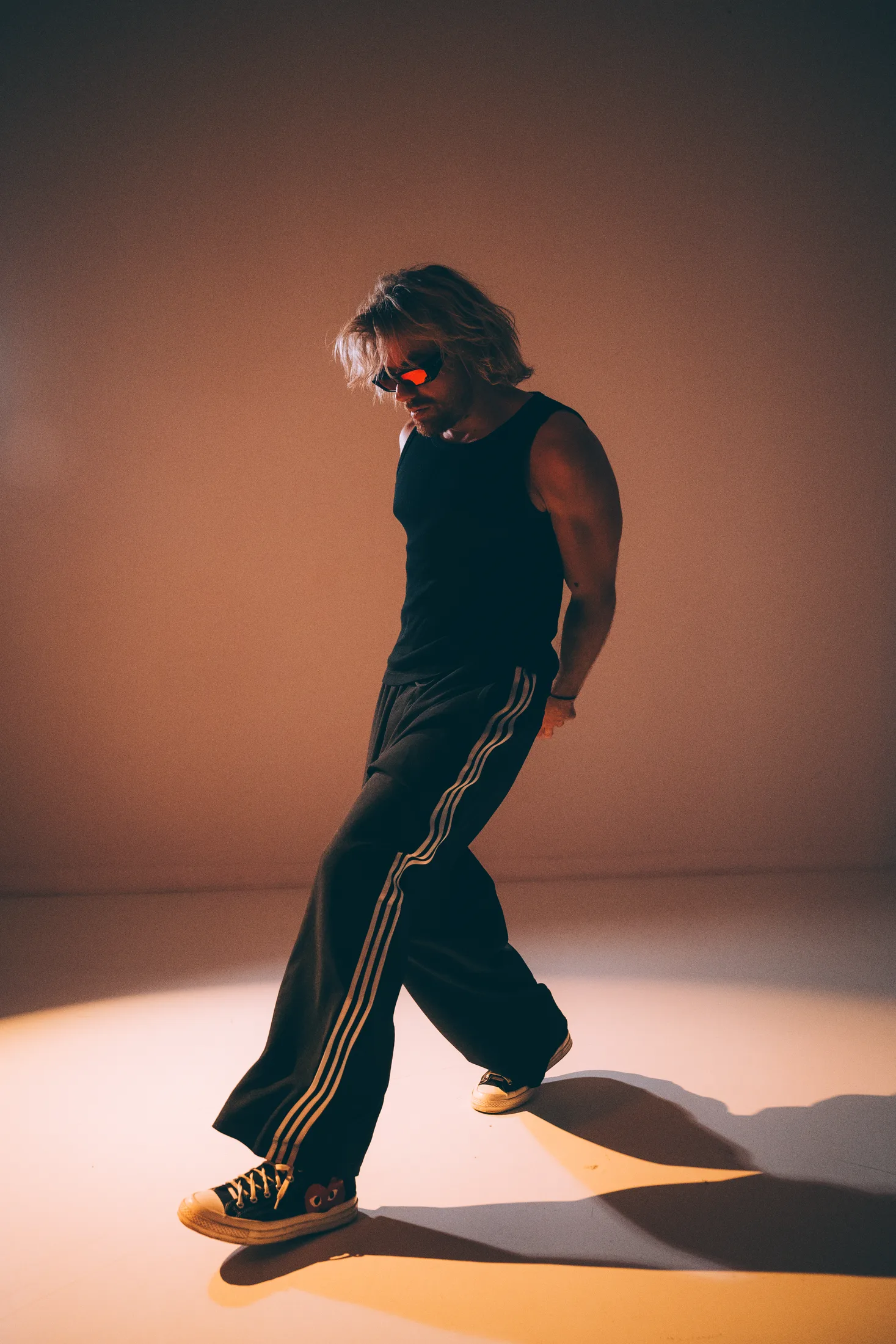 Goldcher walking through a warm spotlight